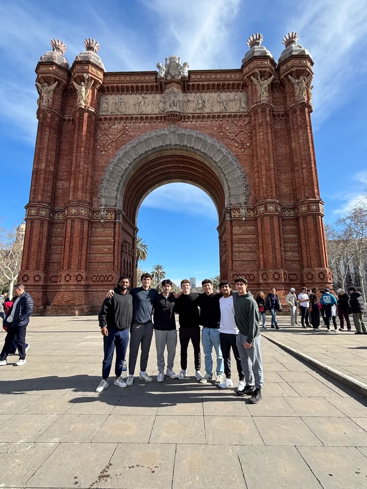 Efe Dincaslan with friends at the Arc de Triomf in Barcelona, Spain